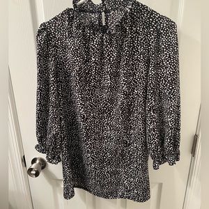 Black and white patterned high neck blouse